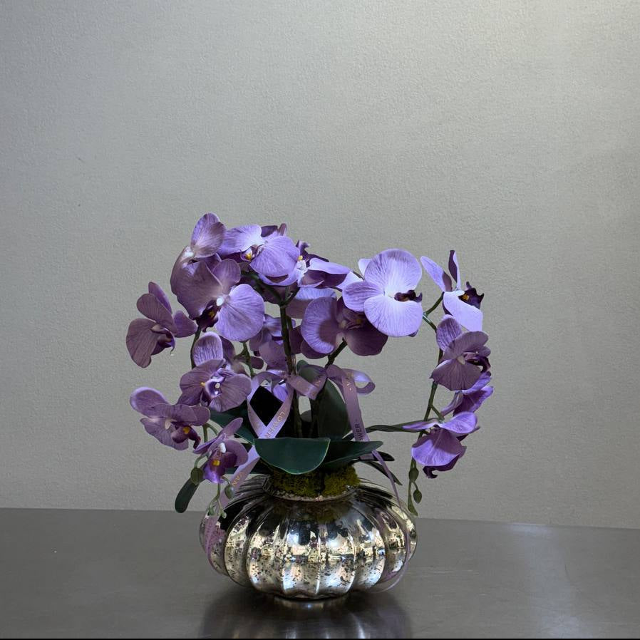 Lavender artificial orchid dome in a round silver glass vase – Vanda Flower Boutique
