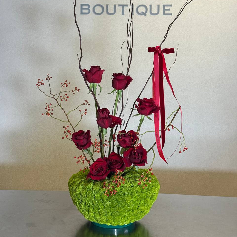 Medium elegant red rose arrangement with green base, berries and red ribbon – Vanda Flower Boutique