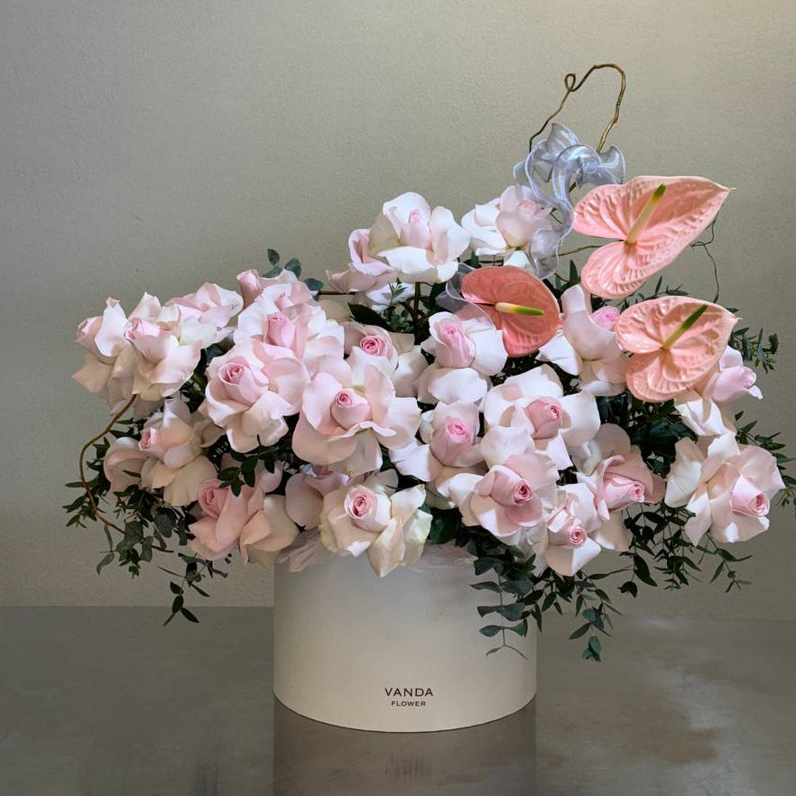 Luxury pink floral arrangement in a white flower box with orchids, anthuriums, and greenery. Perfect for special occasions like birthdays, anniversaries, and congratulations